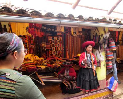 Shina listens to a weaver from Chinchero talk about the creative process that goes into making textiles. 