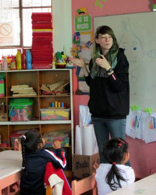 Lydia works with the children in her class on the sign for sandia, or watermelon, in Peruvian Sign Language.