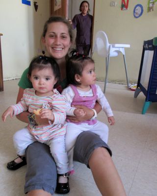 Mariah with twin girls, just over a year old, at Hogar Casa Luz orphanage.