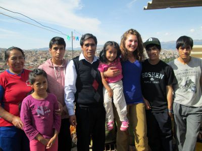 Elizabeth poses with her host family on their porch overlooking Ayacucho.