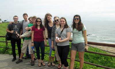 Students pose for a group photo along the malecón after their picnic lunch.