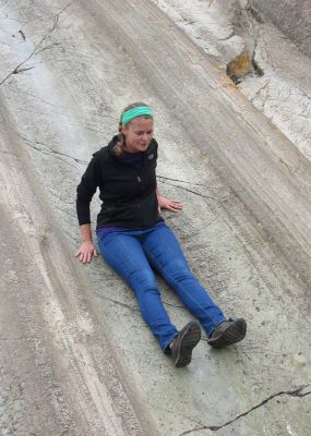 Jo masters a natural rock slide at the Incan site Saqsayhuaman in Cusco.