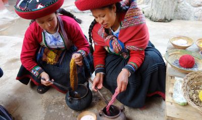 The women apply the dyes to the wool.