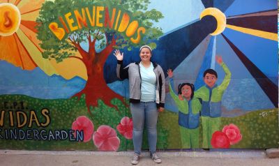 Behind Rachel is a mural painted by previous GC volunteer Maddie Gerig.