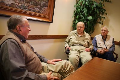 Gordon Yoder, associate director emeritus of college relations for Goshen College (left), visits with Milo Albrecht (center) and Herb Roth (right) at the Apostolic Christian Restmor in Morton, Illinois, in November, 2014. 