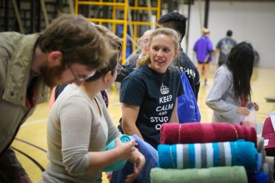 Brianne Brenneman helps pack MCC relief kits for Syrian Refugees during a basketball halftime event, sponsored by GC’s Service Club.