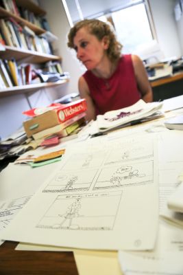 Jessica Baldanzi, associate professor of English, looks over drafts of comics created by students.