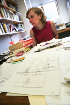 Jessica Baldanzi, associate professor of English, looks over drafts of comics created by students. 