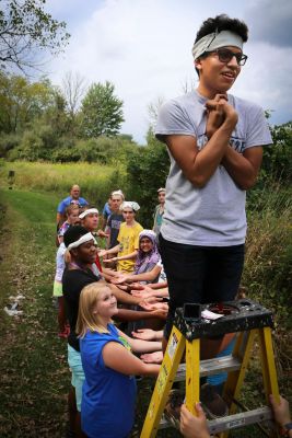 Rafael Zuniga, a first-year student from Goshen, prepares for a trust fall with other incoming students during New Student Days activities at Merry Lea Environmental Learning Center on Sunday, Aug. 28.