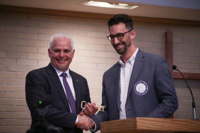Goshen Mayor Jeremy Stutsman present a key to the city to President Brenneman