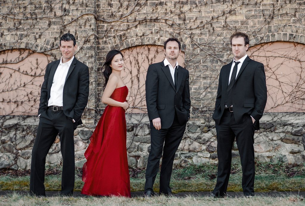 One women in a red dress with four men in black tuxes