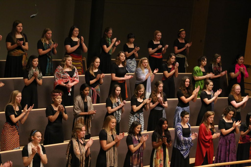 Women's World Choir clapping to one of the songs they are performing.