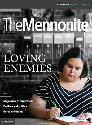 Cover of The Mennonite with a picture of a woman writing in a journal in the right bottom corner.