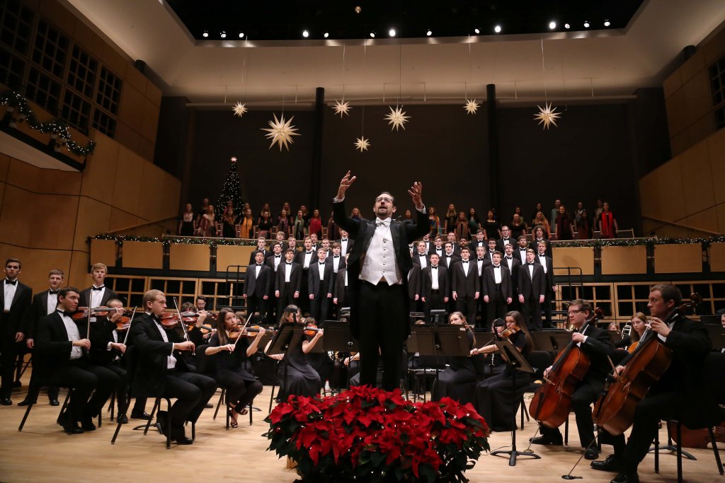 The orchestra and choirs conducted by Male Professor during a performance for Christmas