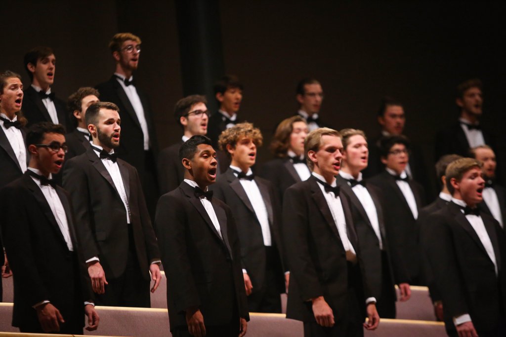 Mens Choir standing while singing in Sauder Concert Hall.