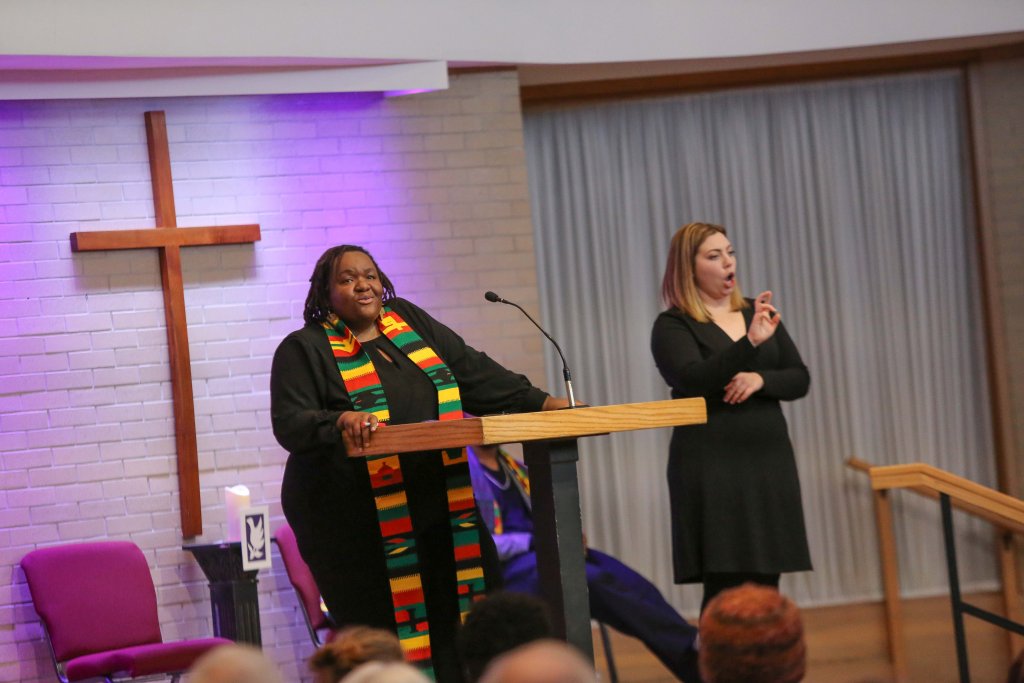 Dr. LaKendra Hardware preaching in the church chapel with ASL interpreter Mia Engle.