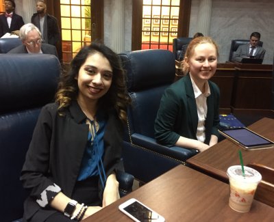 Two women sitting behind a desk