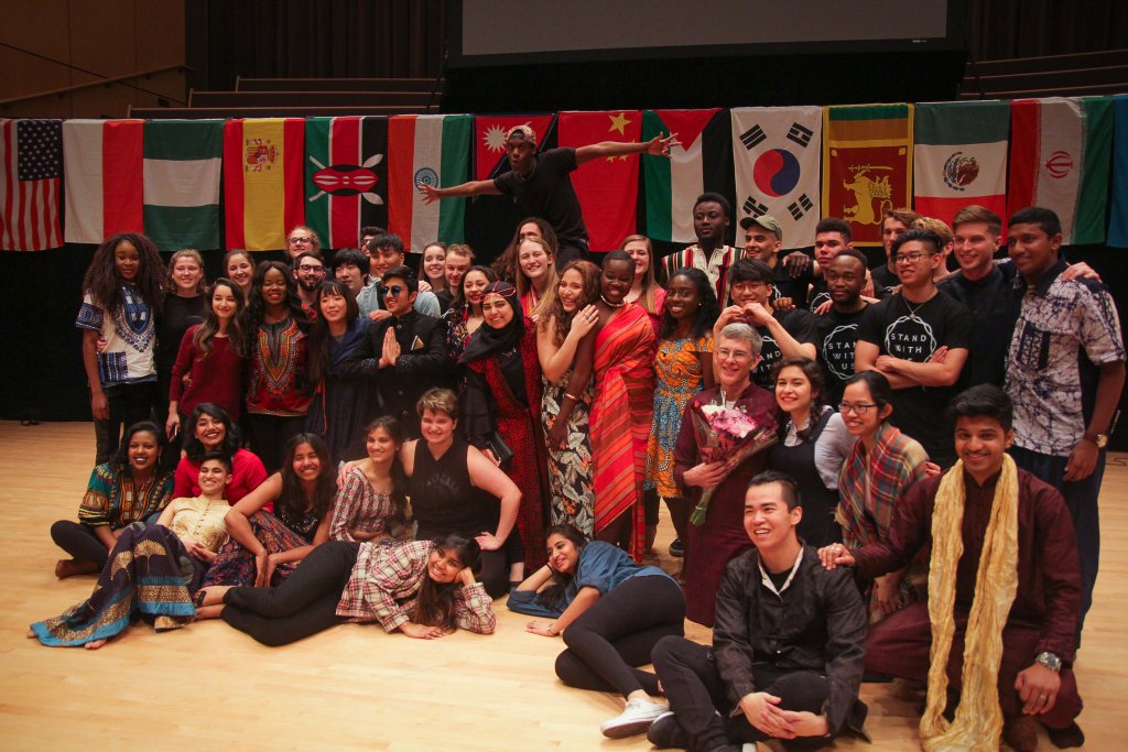 International Students surrounded by flags from many different countries