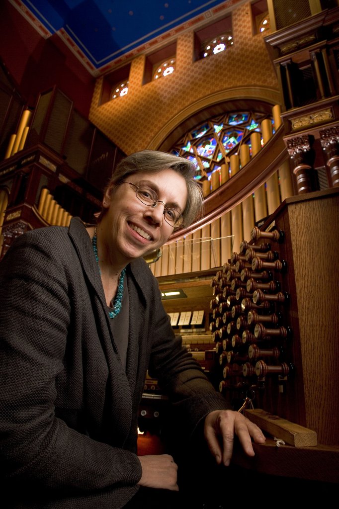 Woman sitting in front of an organ