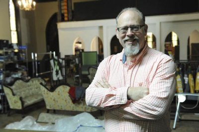 Kevin Koch standing in front of various pieces of furniture