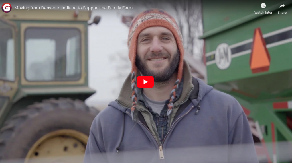 Man standing in front of tractor