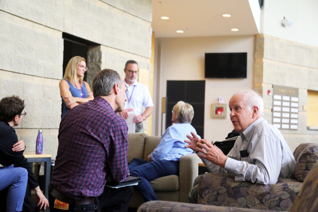 A group of people sitting in a group and talking