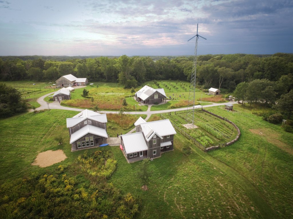 Airplane view of a farm with five buildings on the property