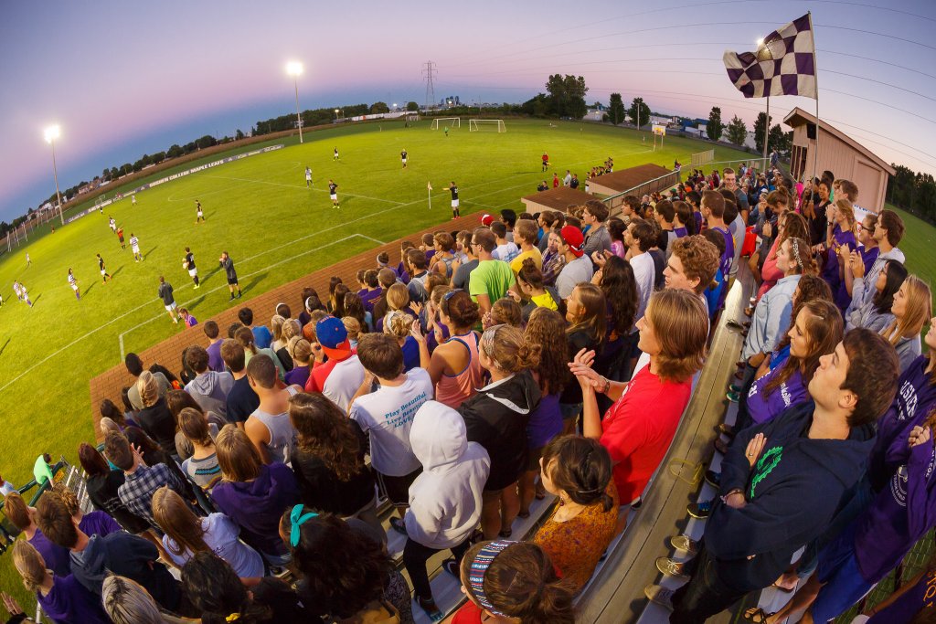 A stadium full of people watching a sports game