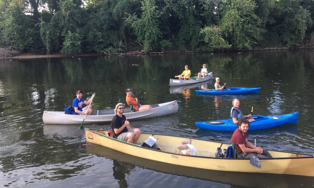 A group of people in kayaks and canoes on the water