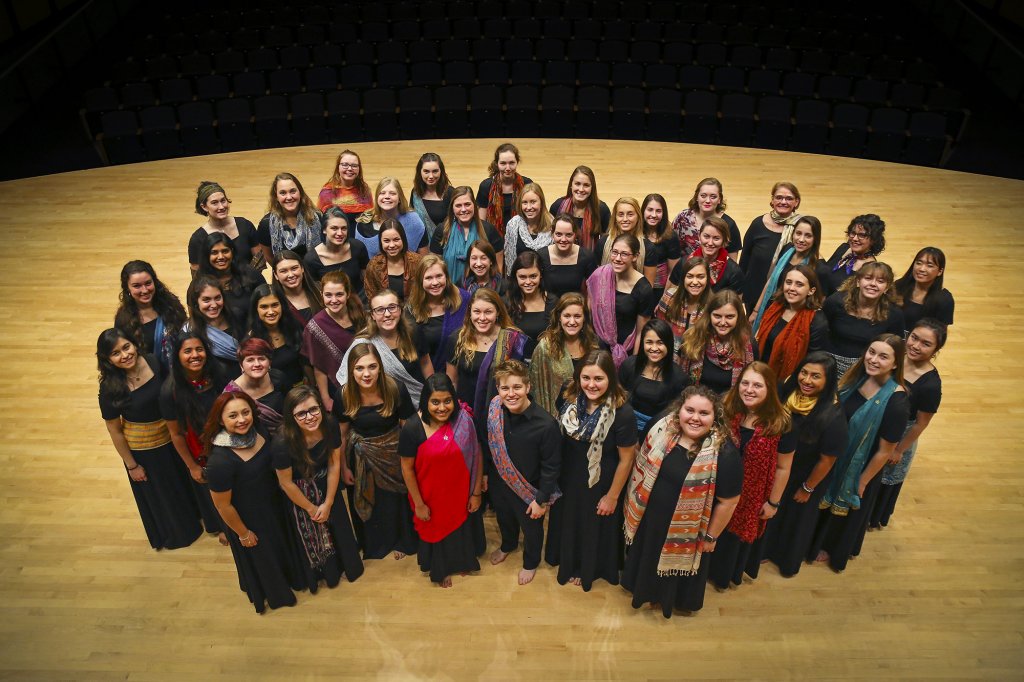 Large group of women in choir apparel looking up at the camera