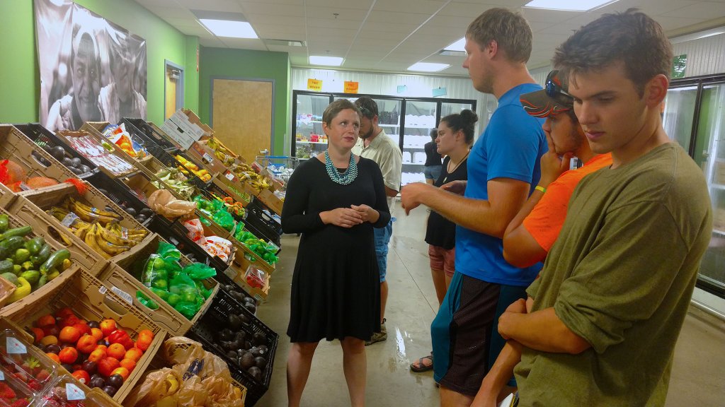 Group of people looking at fruit in the grocery store