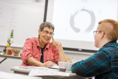 Professor Joann Brant talking with student