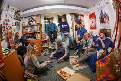 A group of students talking and playing games in one of Goshen’s traditional residence halls